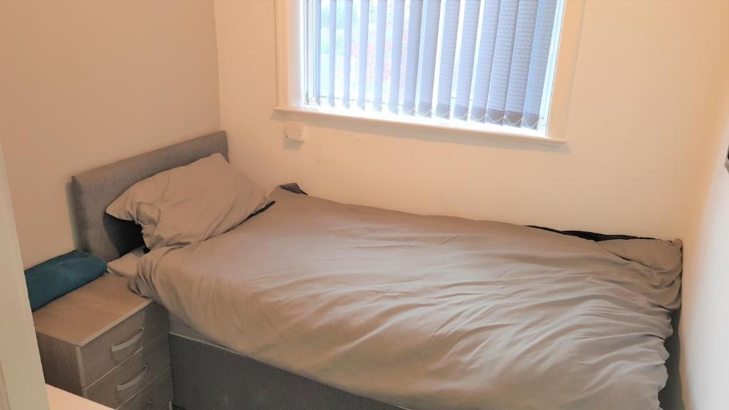 a small bedroom with a bed and a window at Single Bedroom In Withington M20 1 Single Bed, RM4 in Manchester