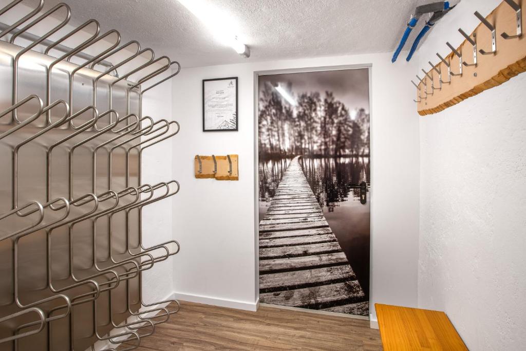 a hallway with a painting of a wooden pier at Alpine View Apartments in Niedernsill