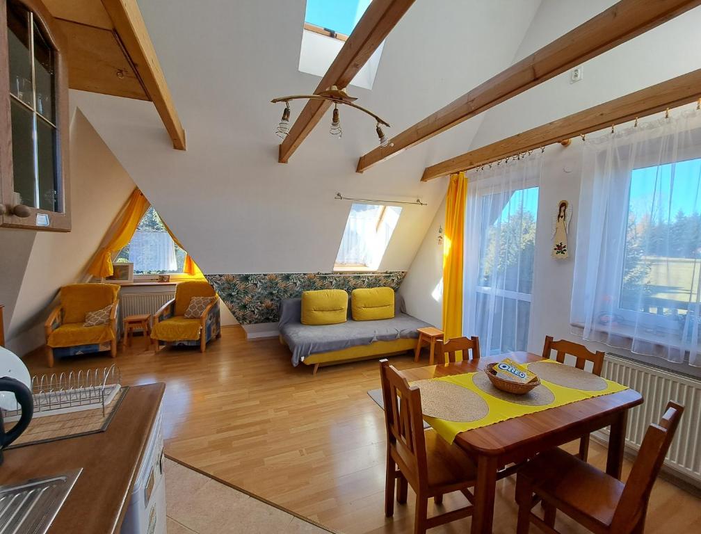a living room with a table and a couch at Apartament Słoneczny in Zakopane