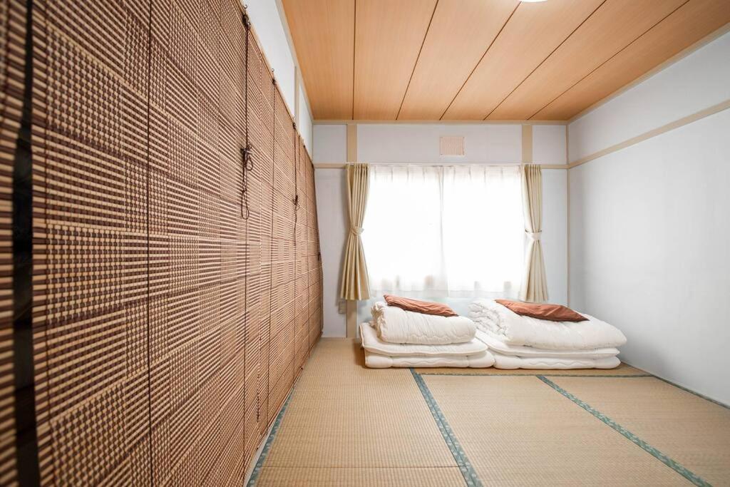 Postel nebo postele na pokoji v ubytování Otaru Shikkui Cottage