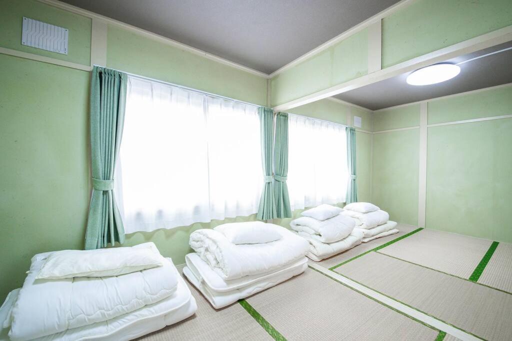 Postel nebo postele na pokoji v ubytování Otaru Shikkui Cottage
