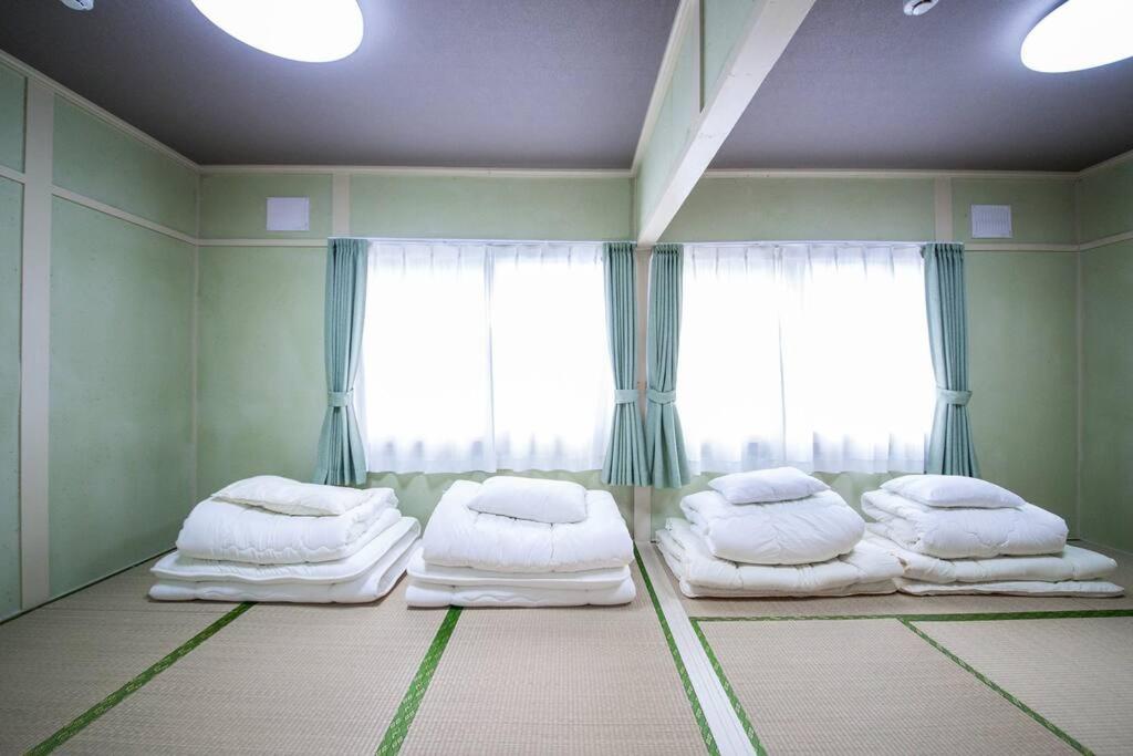 Postel nebo postele na pokoji v ubytování Otaru Shikkui Cottage