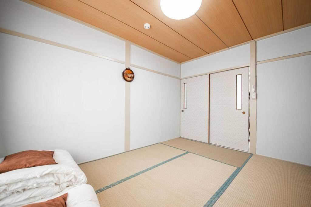 Postel nebo postele na pokoji v ubytování Otaru Shikkui Cottage