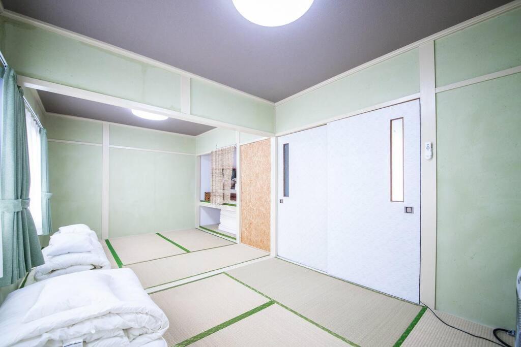 Postel nebo postele na pokoji v ubytování Otaru Shikkui Cottage