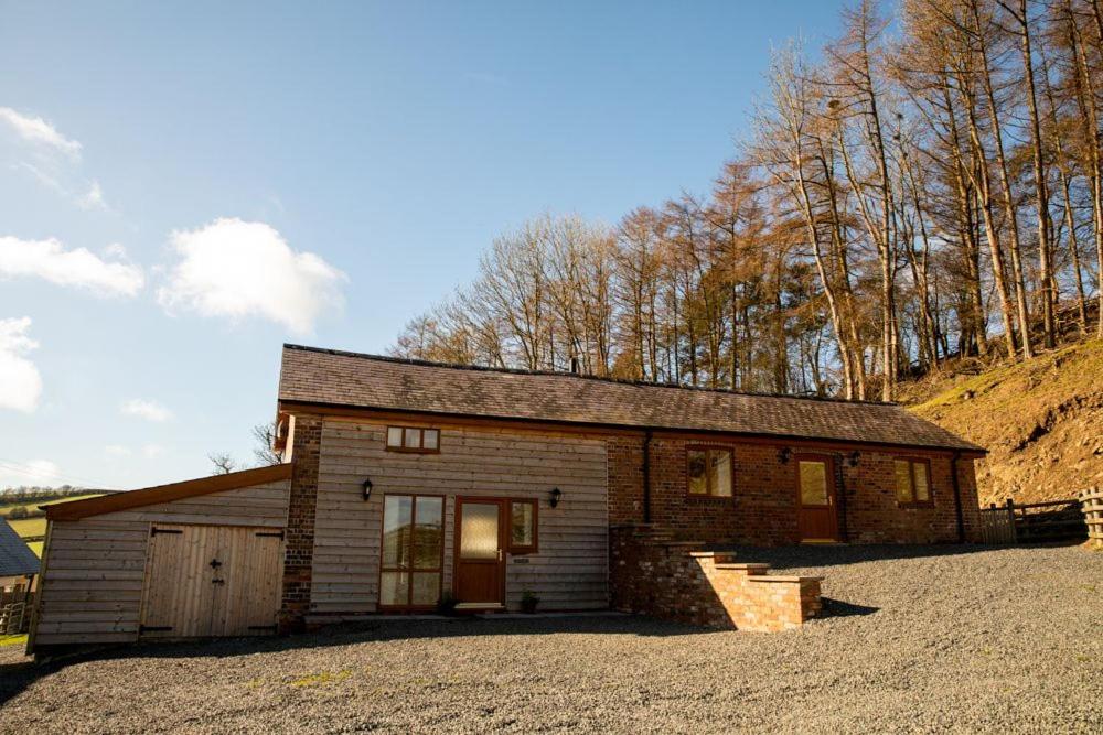 a small log cabin with a garage at Pentre Fach in Llanddewi Ystradenny