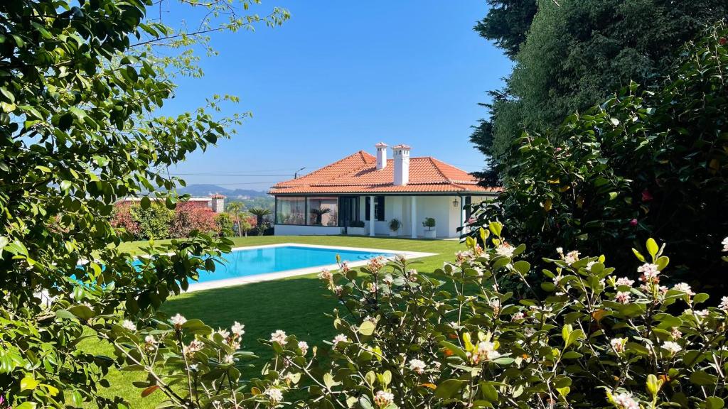 a house with a swimming pool in a yard at Solar da Boavista in Rebordões