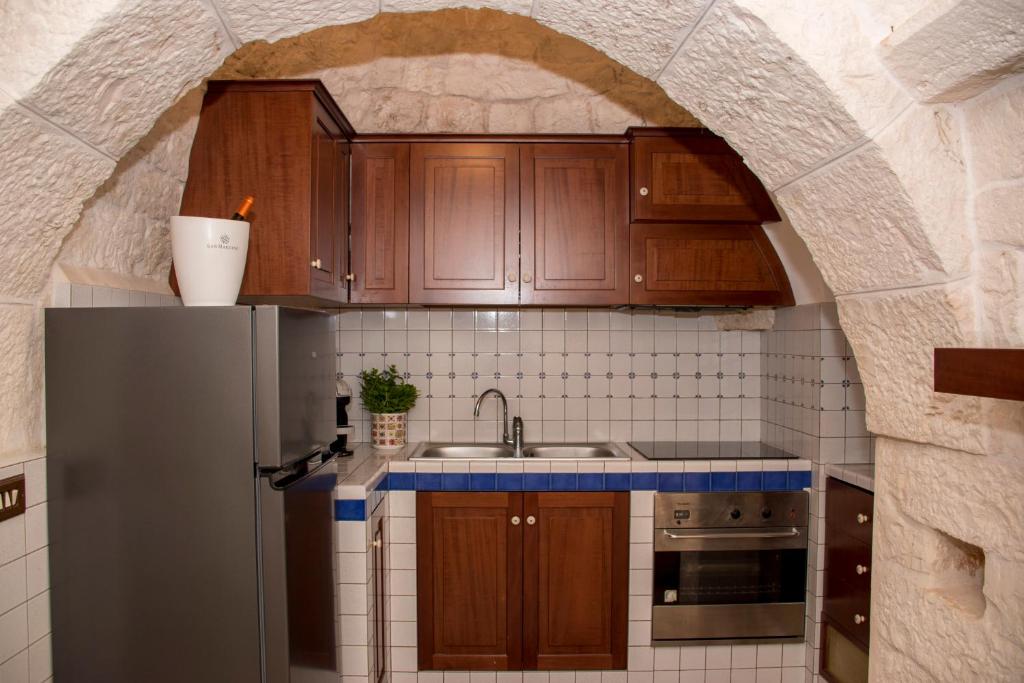 Kuchyň nebo kuchyňský kout v ubytování Pavì Trulli e Suites