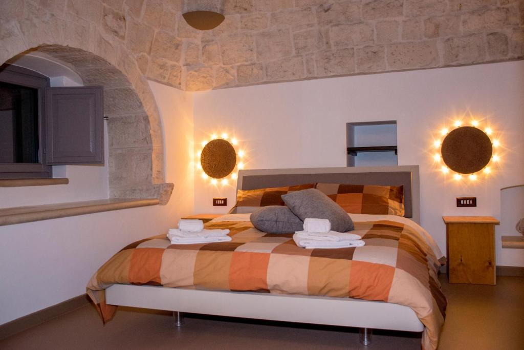 a bedroom with a large bed in a room at Pavì Trulli e Suites in Locorotondo