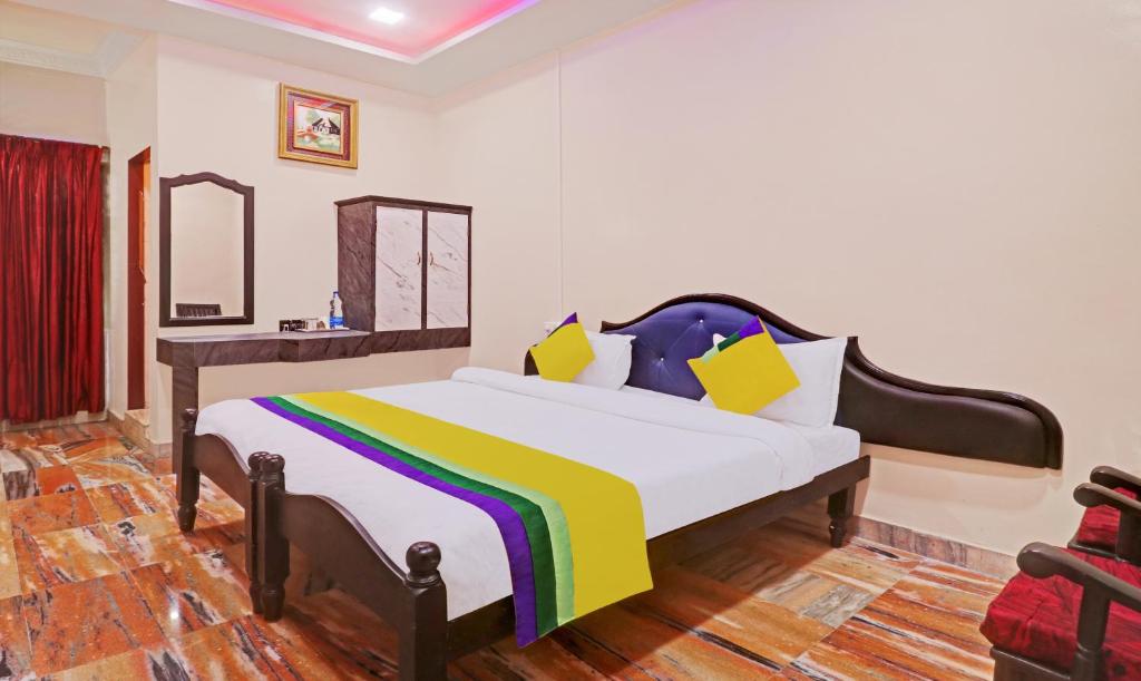 a bedroom with a large bed with a colorful blanket at Itsy By Treebo - Hill Town 500 Mtrs From Madikeri Fort in Madikeri