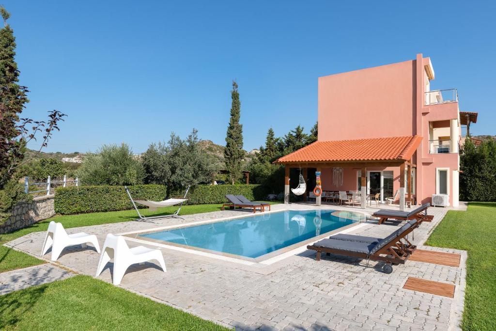 a villa with a swimming pool and a house at Villa Sephora in Faliraki