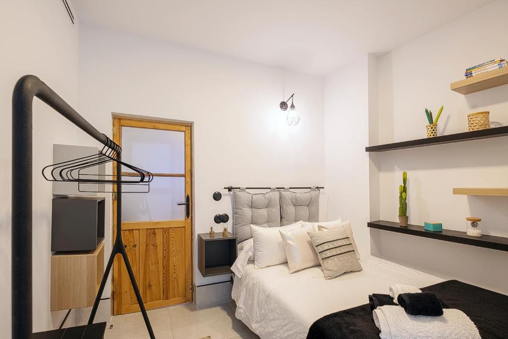 Łóżko lub łóżka w pokoju w obiekcie Piso-Loft COS Jaén Centro