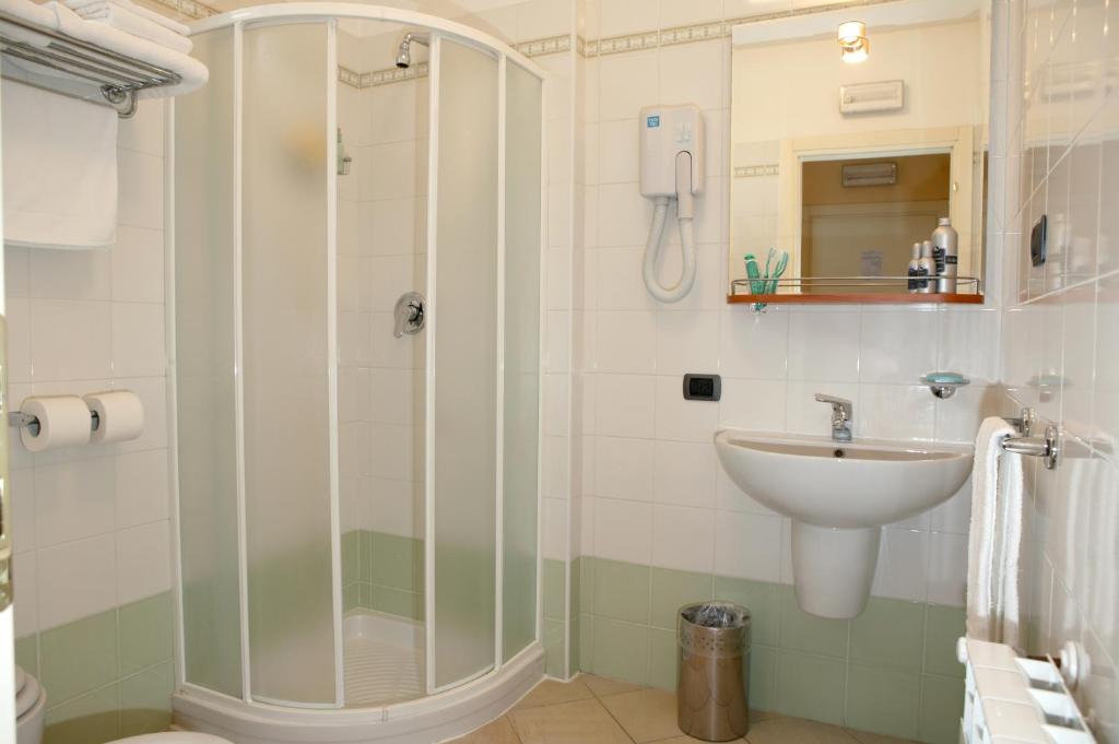 a bathroom with a shower and a sink at Hotel Spinelli in Viareggio
