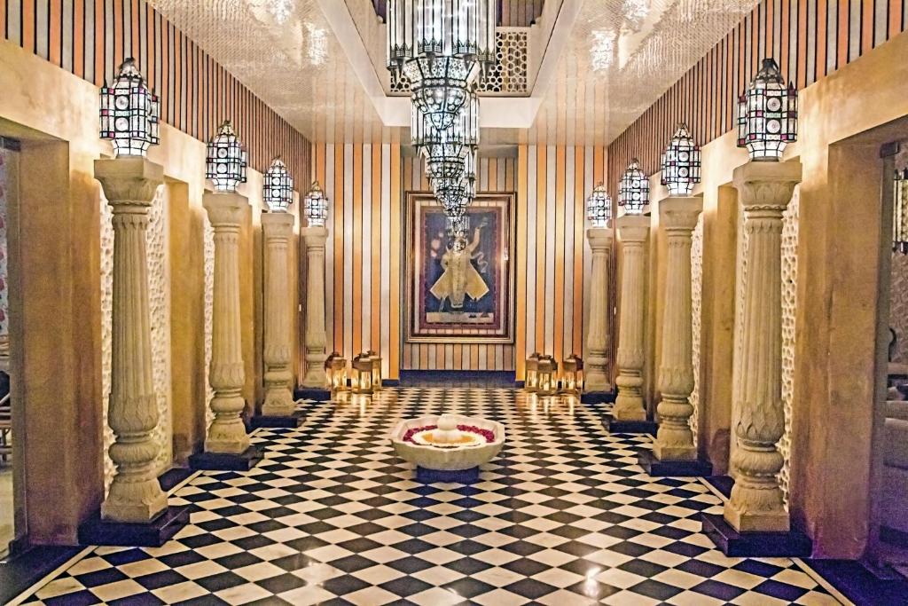 a hallway of a building with a checkered floor at Sonaar Haveli in Jaisalmer