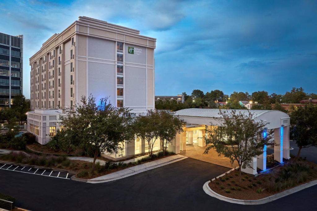 ein großes weißes Gebäude mit Parkplatz in der Unterkunft Holiday Inn Express & Suites Charleston DWTN -Westedge, an IHG Hotel in Charleston