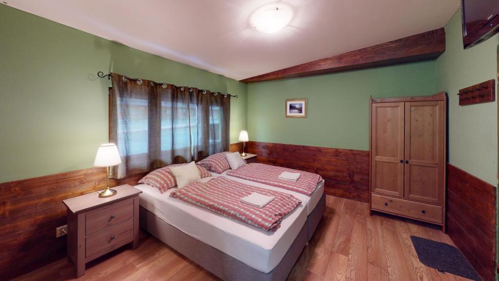 a bedroom with a bed and a dresser in it at Ride Pub Drienica in Drienica