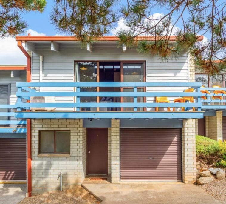 a house with a blue balcony on top of it at Jindang House - Spacious Three Bedroom Townhouse in Jindabyne