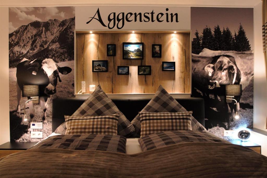 ein Schlafzimmer mit einem Bett mit einem Poster von Kühen in der Unterkunft Aggenstein - Helles Studio mit Südbalkon und traumhaftem Bergpanorama in Pfronten Mitte in Pfronten