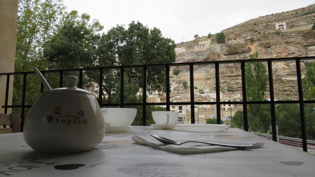 a table with a tea pot sitting on top of a table at Alojamiento Rural Singular Pepe el Tranquilo in Alcalá del Júcar