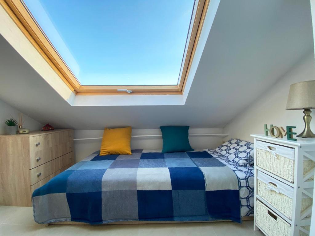 um quarto com uma cama e uma clarabóia em LK17 - Loft in the Center em Sófia