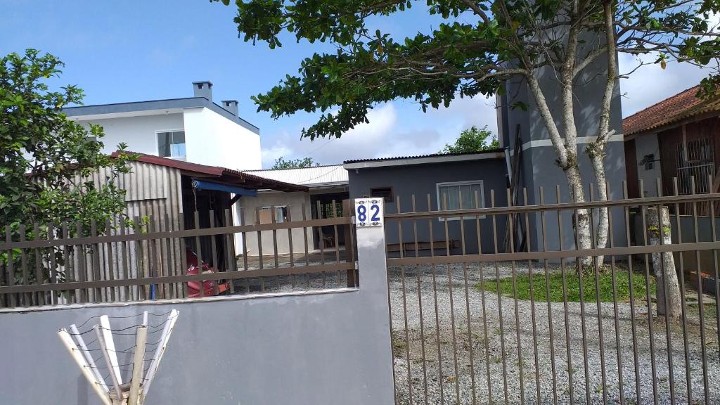 a fence in front of a house with a sign on it at valdemiro flores in São Francisco do Sul