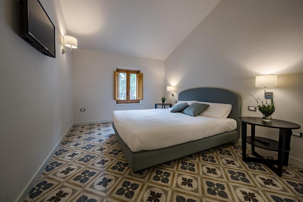 Postel nebo postele na pokoji v ubytování Masseria Agriturismo Torre Di Albidona