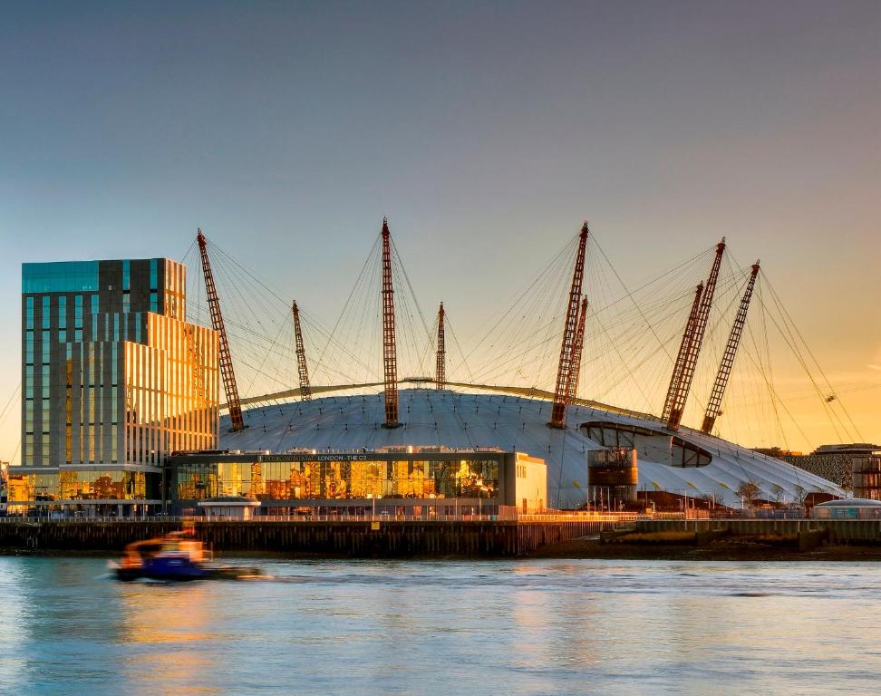 a boat in the water in front of a stadium at Intercontinental London - The O2, an IHG Hotel in London
