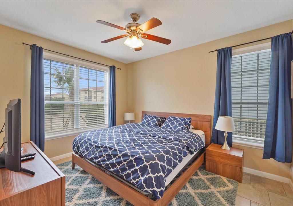 a bedroom with a bed and a ceiling fan at The Dawn on Galveston Beach in Galveston