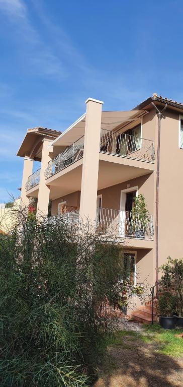 a building with balconies on the side of it at B&B I Colori di Chia in Chia