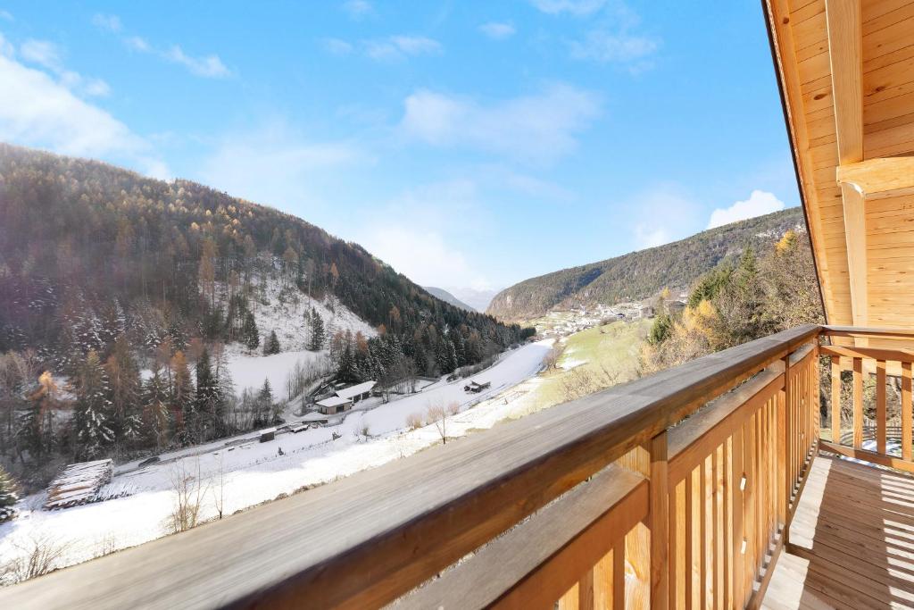 a view from the balcony of a cabin with snow covered mountains at Töniglerhof Apt Morgensonne in Trodena