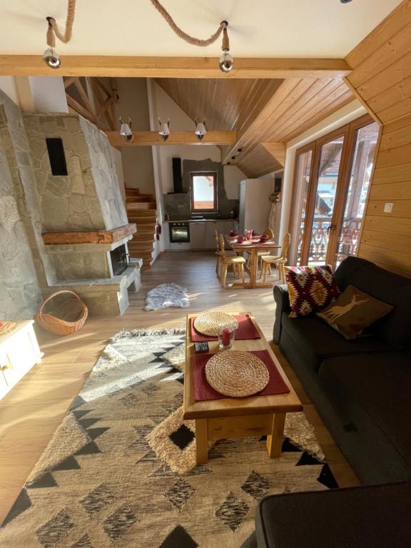 a living room with a couch and a table at Maison de Pieniny in Jaworki