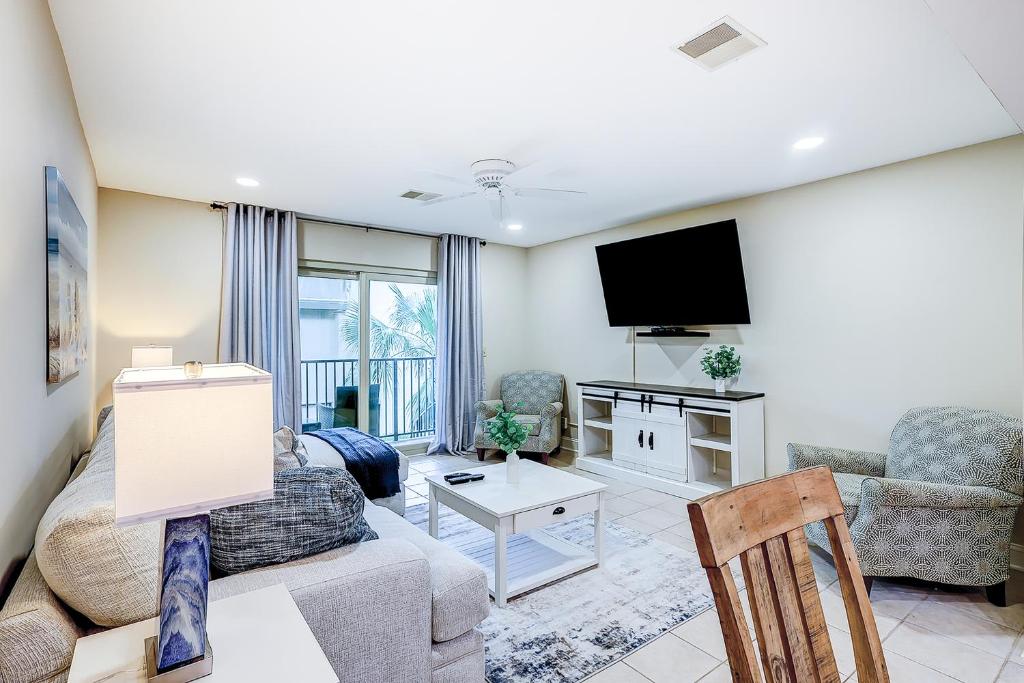 a living room with a couch and a tv at Surf Court Villas 5 in Hilton Head Island