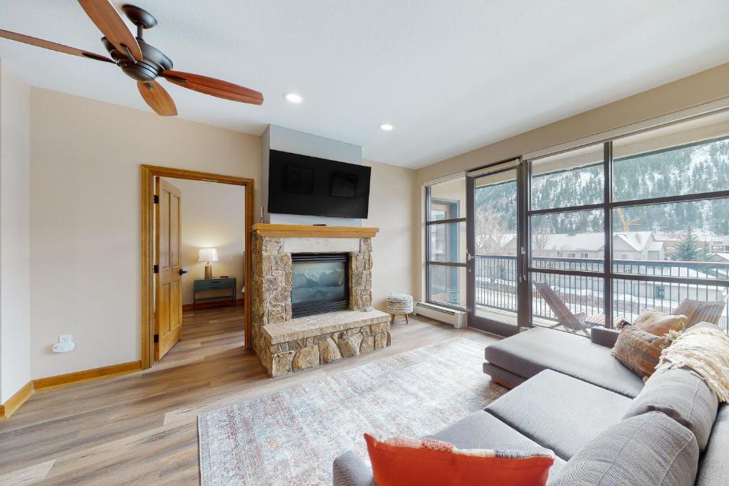a living room with a couch and a fireplace at Chapel Place in Avon