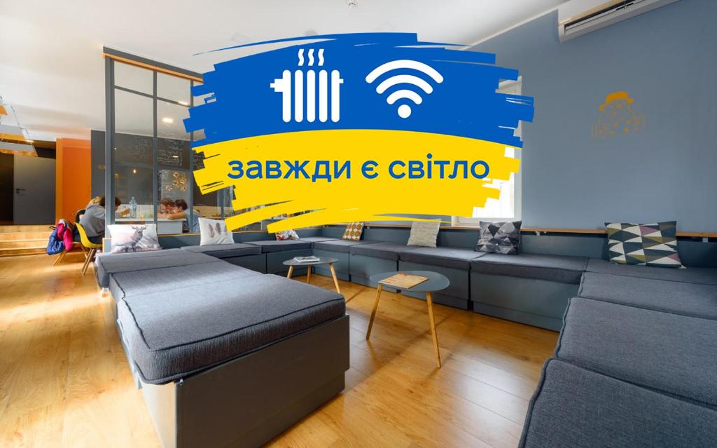 a waiting room with couches and a wifi sign on the wall at Friday Hostel in Odesa