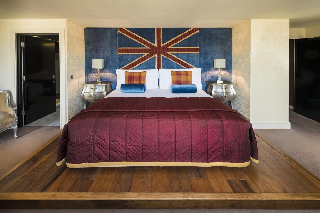 a bed room with a large bed and a painting on the wall at The Chelsea Harbour Hotel and Spa in London