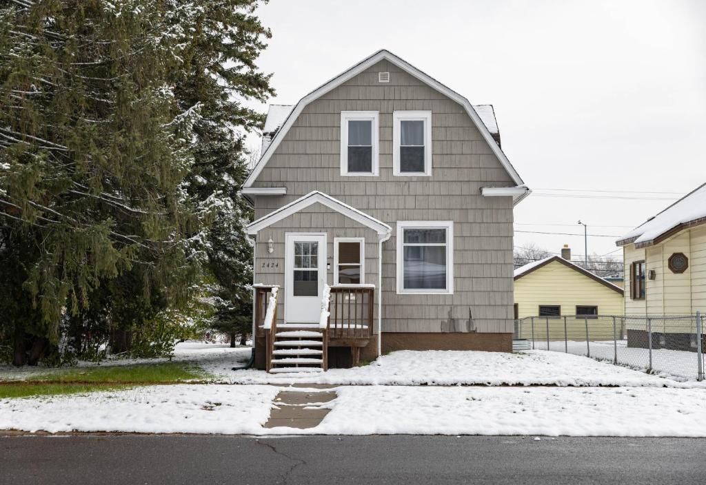 a small house with snow on the ground at 4 Bedroom House by Leavetown Vacations in Superior
