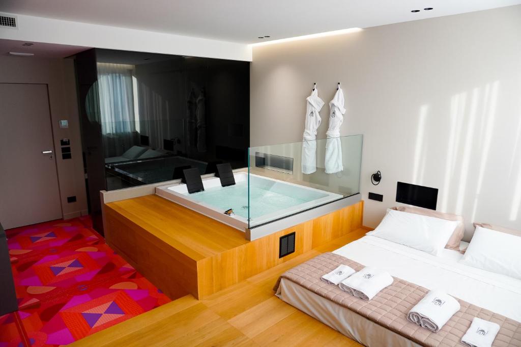 a room with two beds and a swimming pool at ZOE LUXURY SUITES in Catania