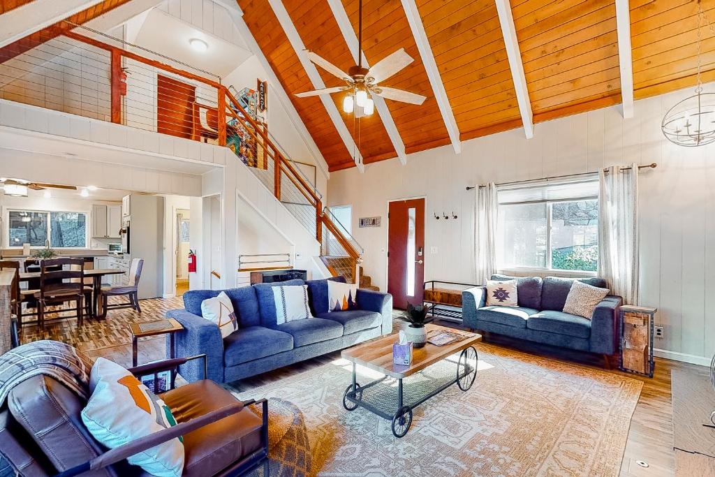 a living room with blue couches and a table at The Retreat on Wabash Lane in Lake Arrowhead
