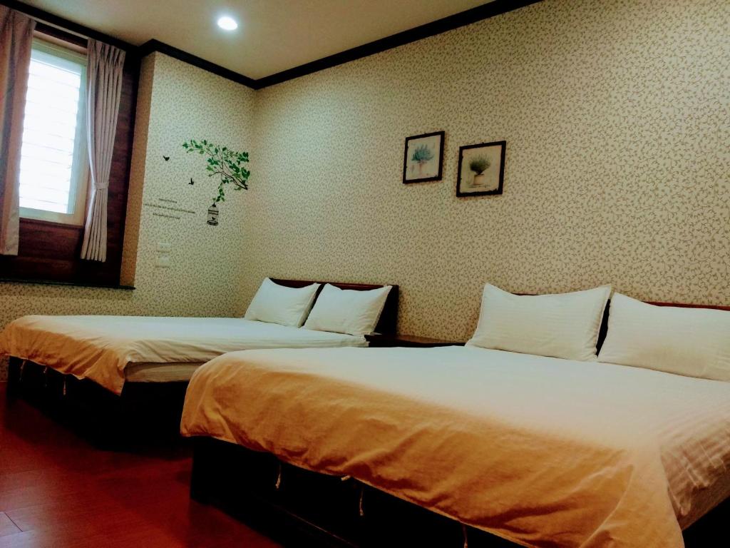 Postel nebo postele na pokoji v ubytování Ju Jia Xiao Zhan Homestay