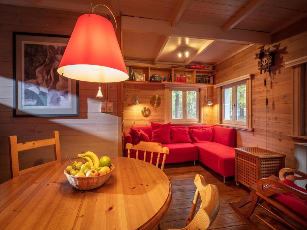 a living room with a red couch and a table at Tranquil bungalow in Lille with garden in Lille