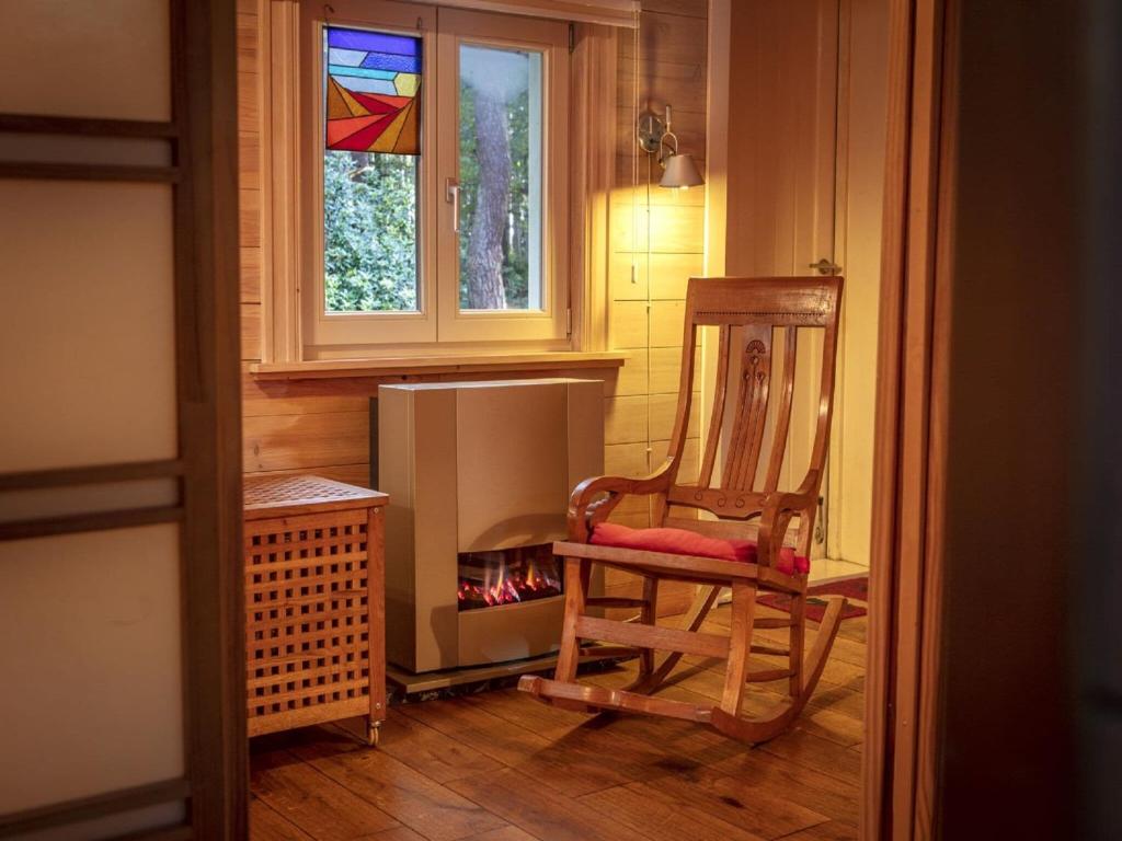 a room with a chair and a stained glass window at Tranquil bungalow in Lille with garden in Lille