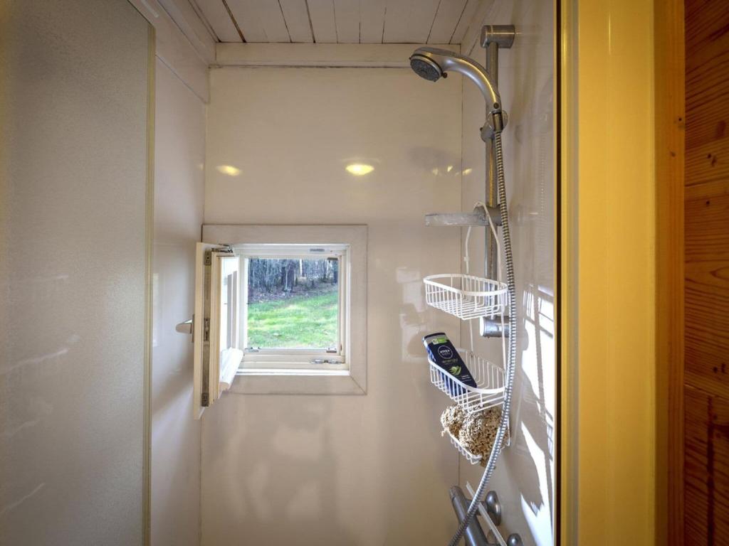 a bathroom with a shower and a window at Tranquil bungalow in Lille with garden in Lille