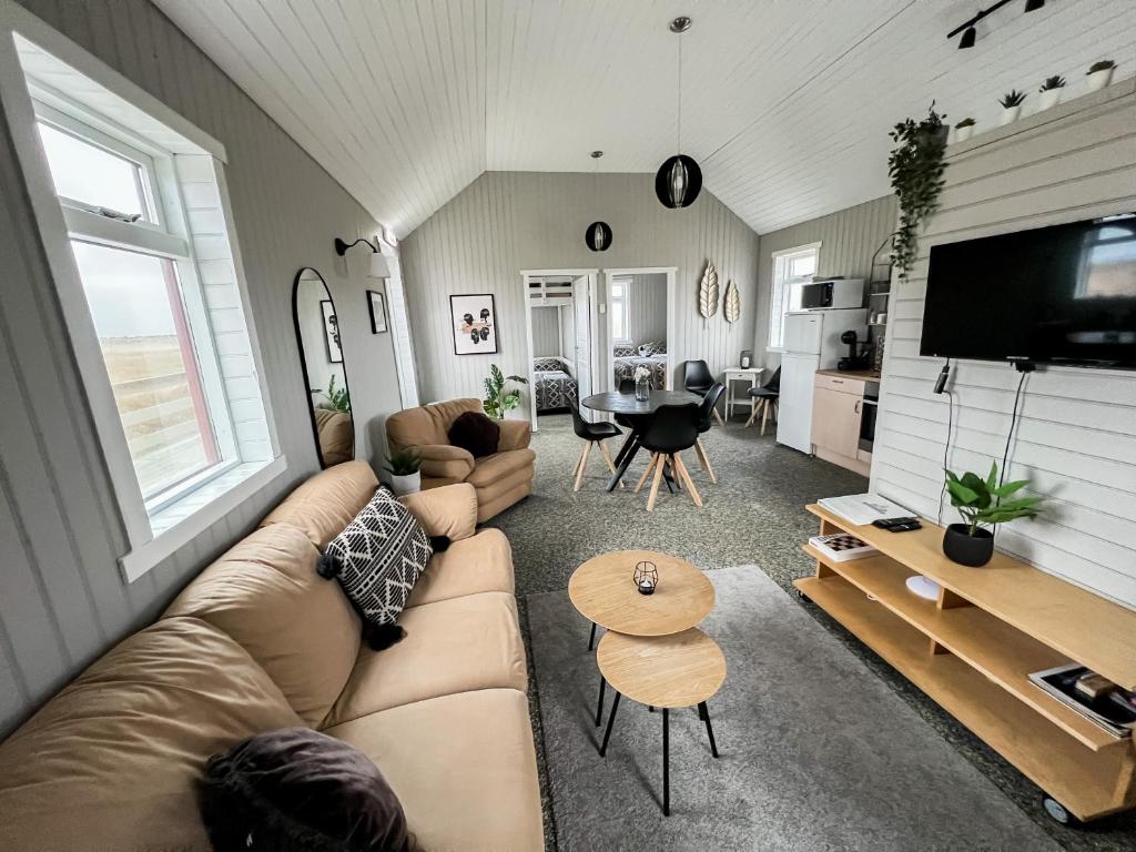 a living room with a couch and a table at Garður Apartments in Gardur