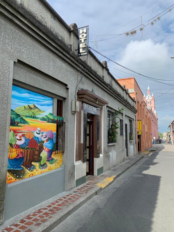 a mural on the side of a building on a street at HOTEL LA CASONA in Buga