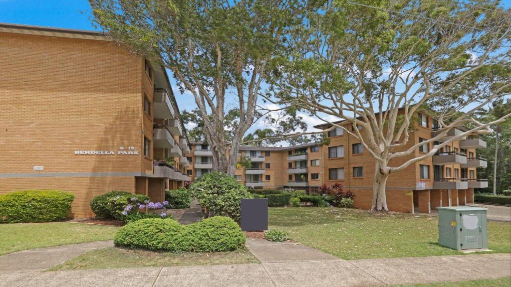 an apartment building with a trash can next to a sidewalk at Berdella Park 9 in Port Macquarie