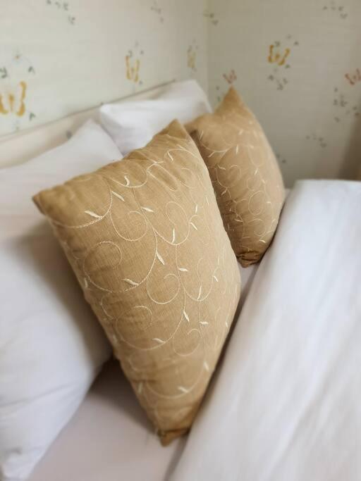 two pillows sitting on top of a bed at Jeju Mermuri in Seogwipo