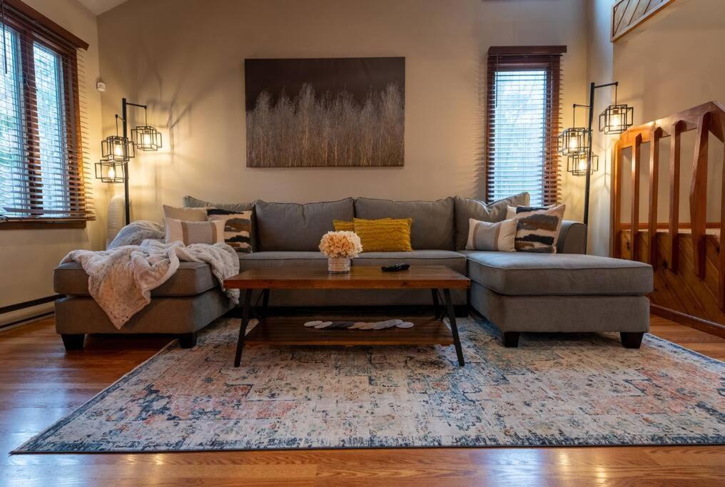 a living room with a couch and a table at Charming Corner Newly Furnished Townhome in Lake Harmony