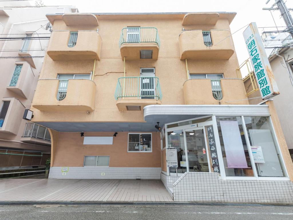 a building with a store in front of it at Tabist Business Ryokan Akashiya Annex in Akashi