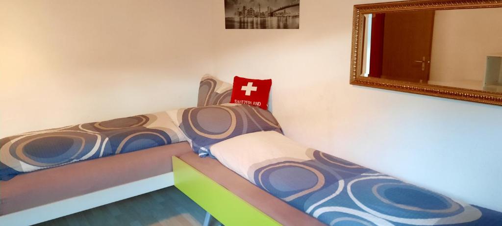 a bedroom with a bed with a red cross on it at Bodmen 3 Apartments von Privat in Zermatt in Zermatt