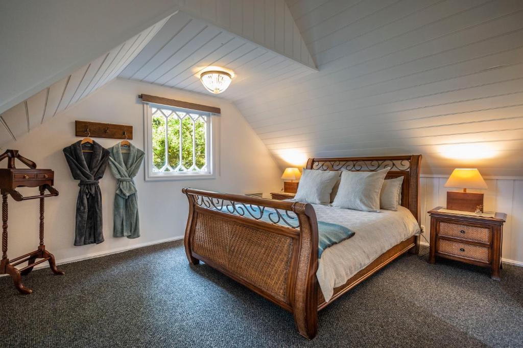 a bedroom with a large bed and a window at Wild Orchid Olinda Private Luxury Cottage in Olinda