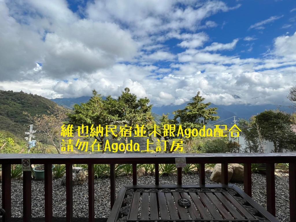 a sign on a bench in front of a mountain at Cingjing Vienna Pleasance Cottage in Ren&#39;ai